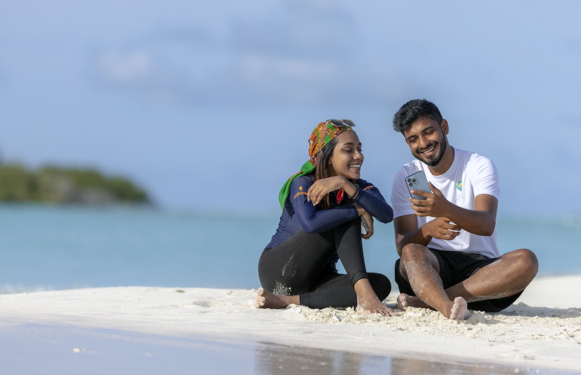 People using FahiPay by the sea